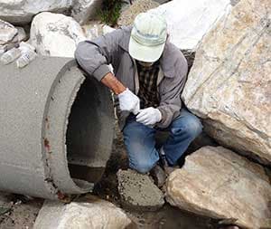 volunteer collecting a sample at Hopkins outfall in Pacific Grove, CA