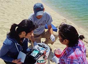 Volunteers check dissolved oxygen at Carmel River State Beach